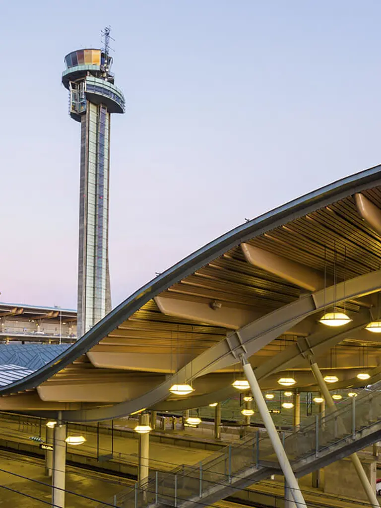 Large building with tower and walkway.
